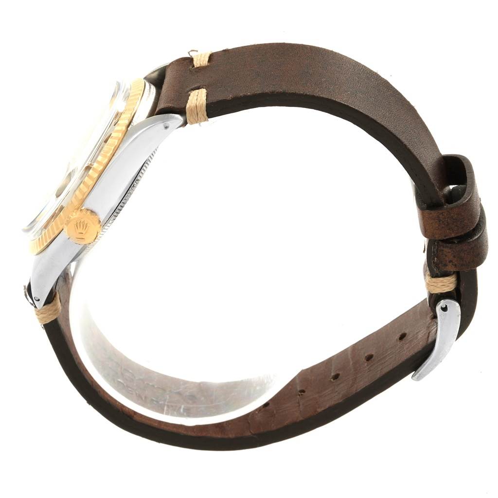 This shows a side angle of a Vintage Collection model Rolex watch, highlighting its brown leather strap, gold bezel, and crown.