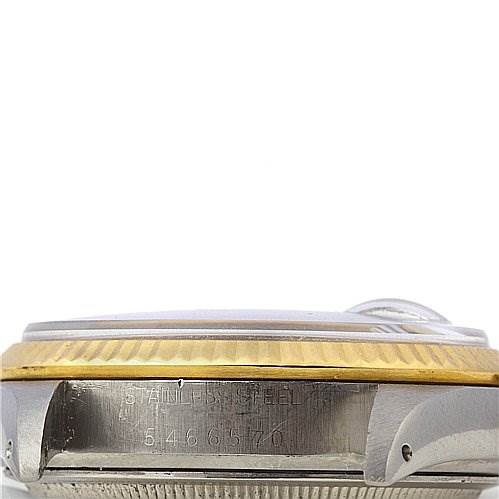 This image shows a side view angle of a Rolex Vintage Collection 16013 Men's Stainless Steel Blue Dial 16013 Men's Stainless Steel Blue Dial watch, focusing on its steel case, gold bezel, and partial serial number.