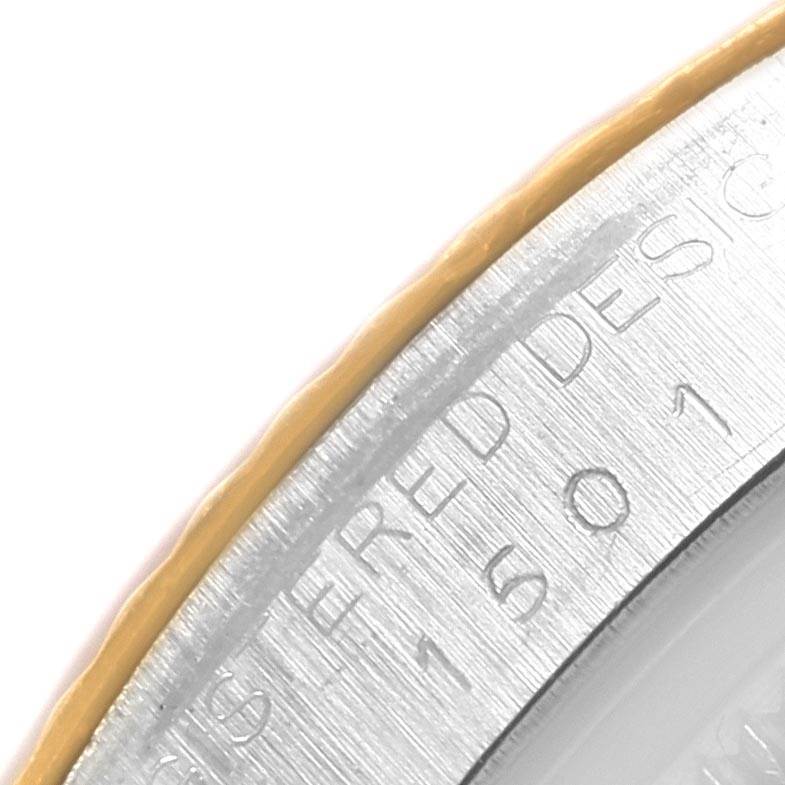 This image shows a close-up angle of the bezel and part of the case back engraving on a Rolex Vintage Collection 1501 Men's Steel and Gold (two tone) White Dial 1501 Men's Steel and Gold (two tone) White Dial watch.
