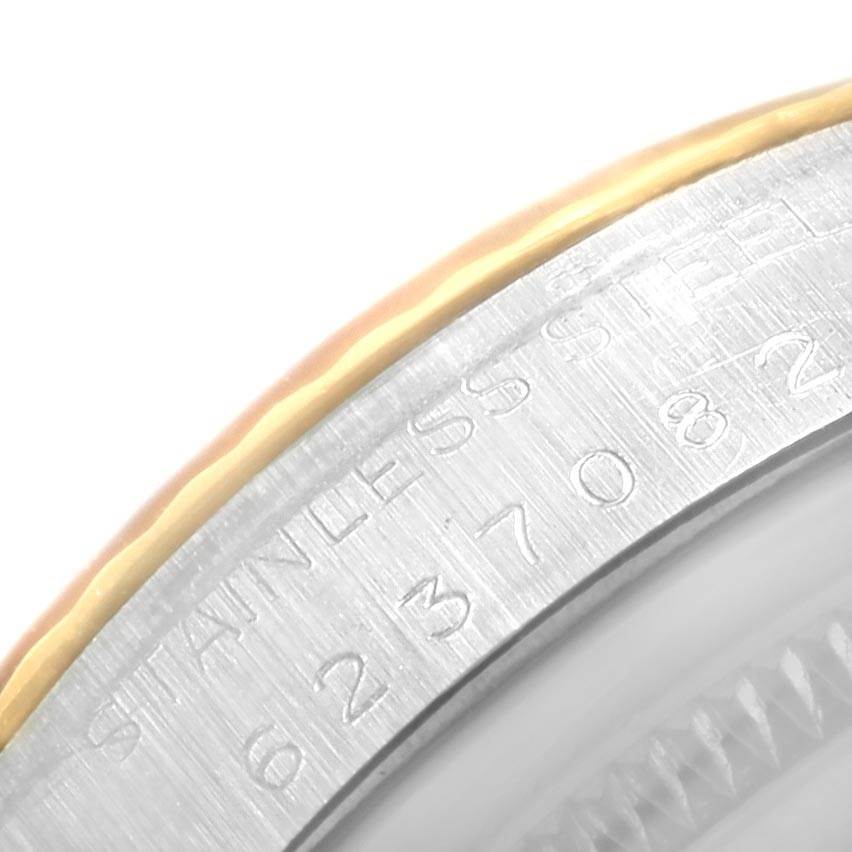The image shows a close-up of the bezel and case edge of a Vintage Collection Rolex watch, highlighting etched details.