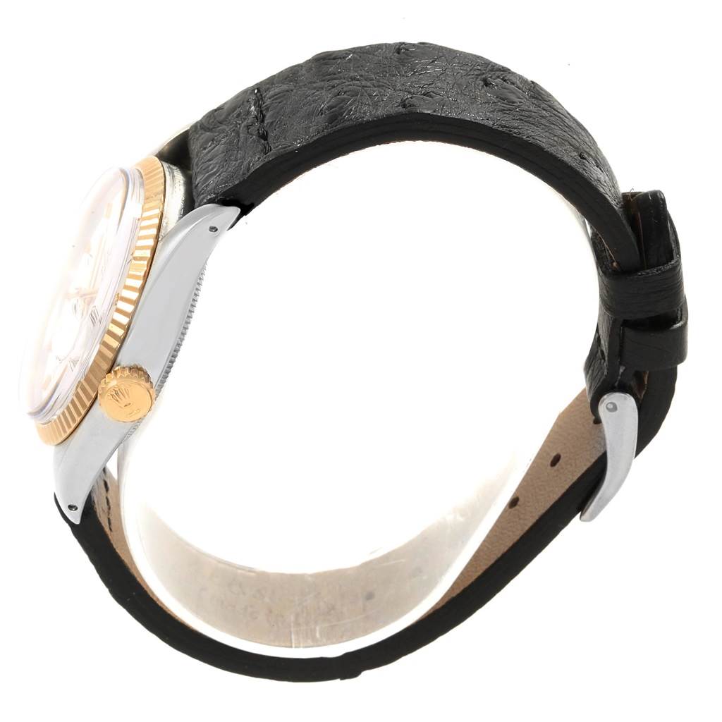 The image shows a side view of the Rolex Vintage Collection 1501 Men's Steel and Gold (two tone) White Dial 1501 Men's Steel and Gold (two tone) White Dial watch, highlighting the bezel, crown, and leather strap.