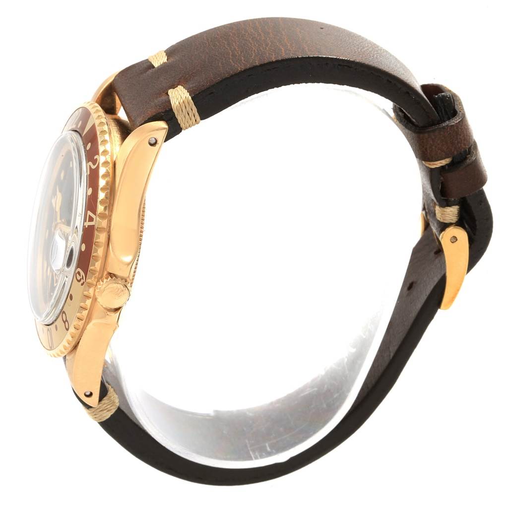 The image shows a side view of the Rolex Vintage Collection 1675 Men's Yellow Gold Brown Dial 1675 Men's Yellow Gold Brown Dial model with the crown, bezel, and brown leather strap visible.