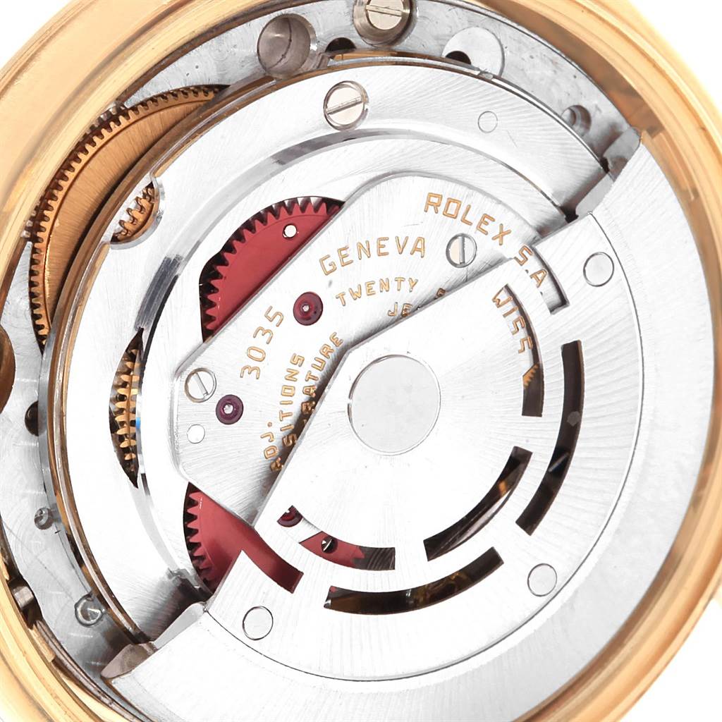 This image shows the intricate internal mechanics of a Rolex Vintage Collection 15037 Men's Yellow Gold Champagne Dial 15037 Men's Yellow Gold Champagne Dial watch, specifically the movement and gears.