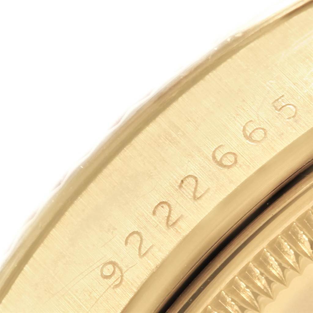 This close-up image shows the engraved serial number on the bezel of the Rolex Vintage Collection 15037 Men's Yellow Gold Champagne Dial 15037 Men's Yellow Gold Champagne Dial watch.