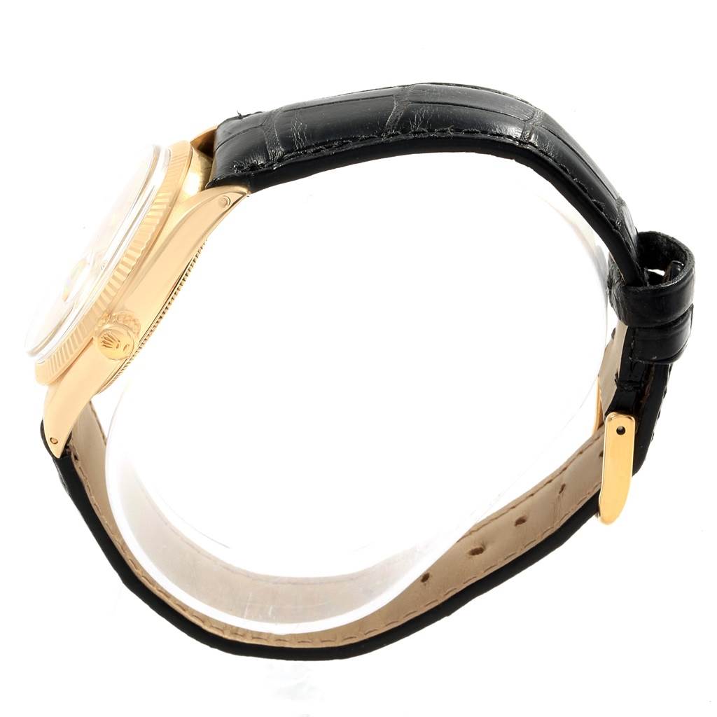 The image shows a side view of a Rolex Vintage Collection 1503 Men's Yellow Gold Silver Dial 1503 Men's Yellow Gold Silver Dial watch, focusing on the crown, case, and leather strap.