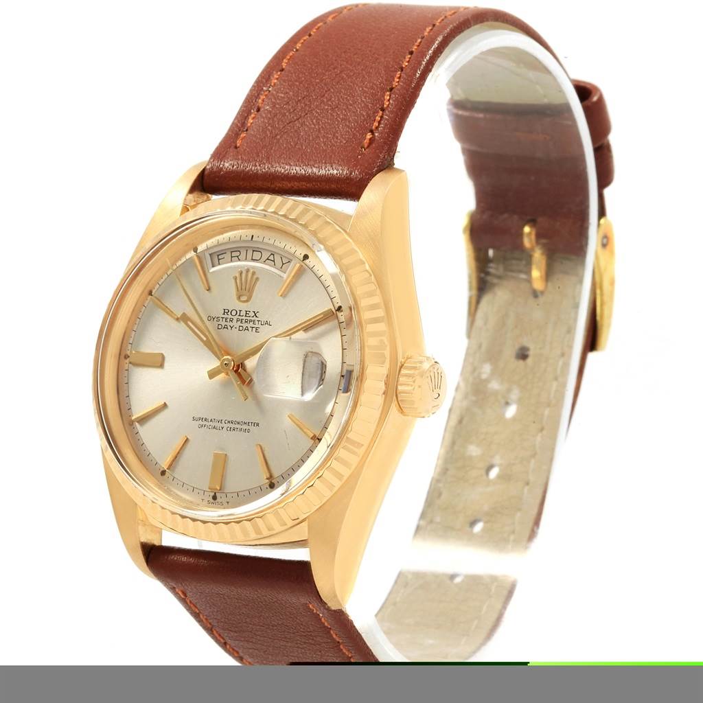 The image shows a Rolex Vintage Collection 1803 Men's Yellow Gold Silver Dial 1803 Men's Yellow Gold Silver Dial watch at an angle highlighting its face, bezel, crown, and brown leather strap.