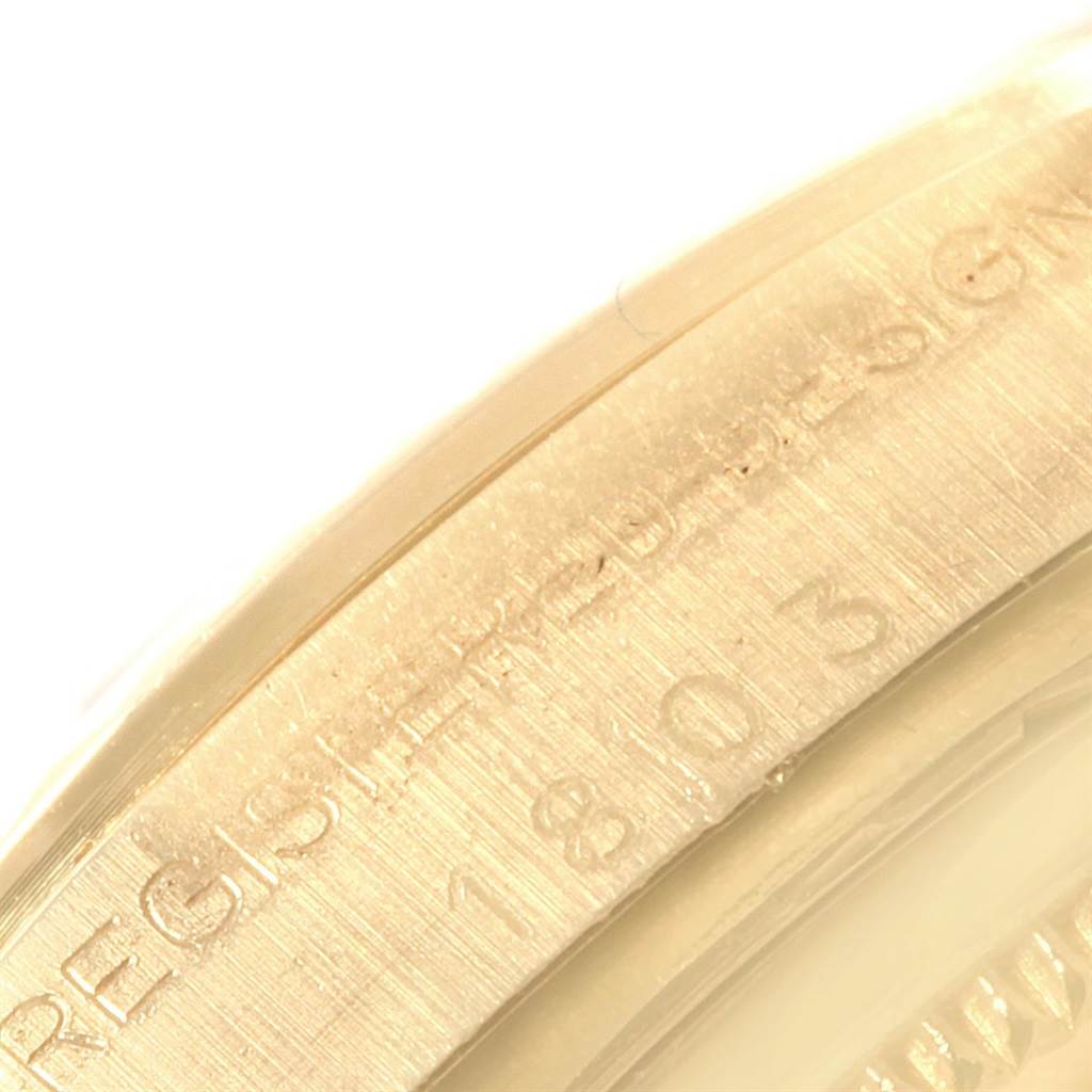This close-up image shows the engraved inner bezel or rehaut of a Rolex Vintage Collection 1803 Men's Yellow Gold Silver Dial 1803 Men's Yellow Gold Silver Dial model watch.