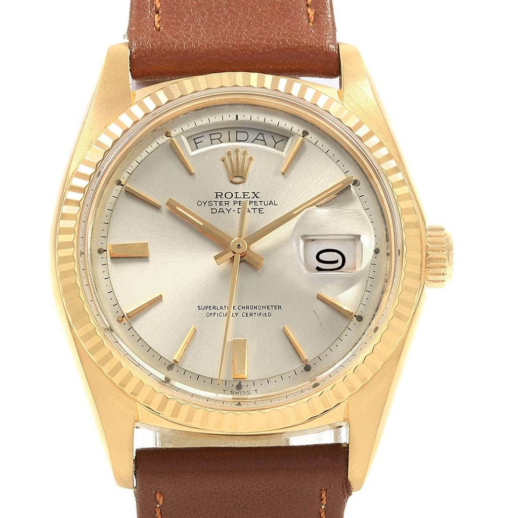 The image shows a close-up of the Rolex Vintage Collection 1803 Men's Yellow Gold Silver Dial 1803 Men's Yellow Gold Silver Dial watch face and part of the leather strap.