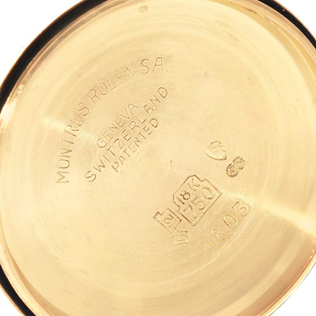 This image shows the inside case back of a Vintage Collection model watch by Rolex, revealing hallmark stamps and engravings.