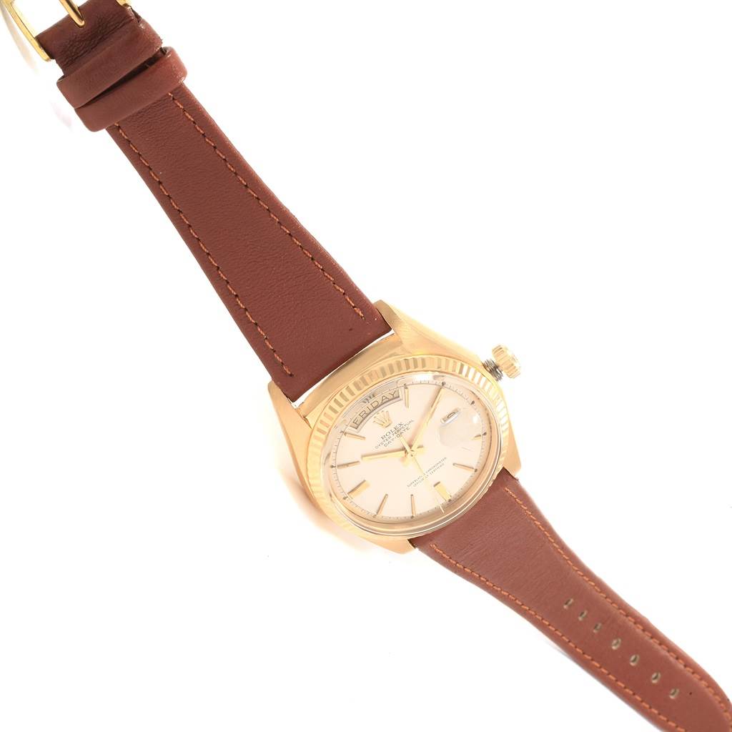 The image shows a Rolex Vintage Collection 1803 Men's Yellow Gold Silver Dial 1803 Men's Yellow Gold Silver Dial watch at an angled top-down view, highlighting the brown leather strap and gold casing.