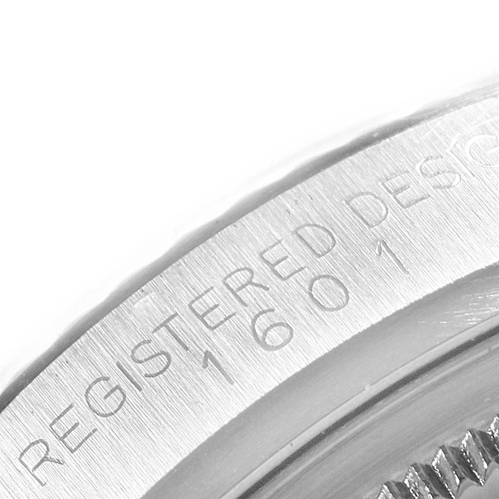 The image shows a close-up angle of the edge with engraved details on the Rolex Vintage Collection 1601 Men's Stainless Steel Silver Dial 1601 Men's Stainless Steel Silver Dial model.