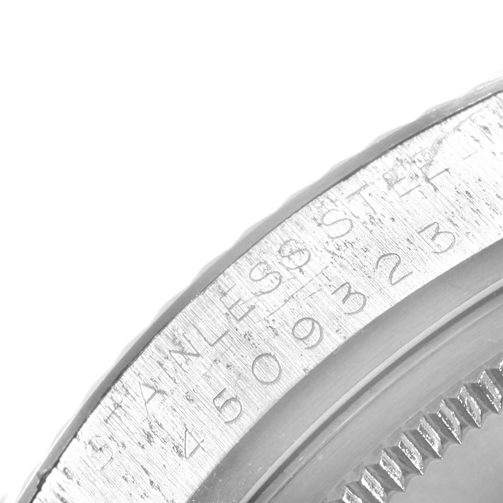 The image shows a close-up of the side of a Rolex Vintage Collection 1601 Men's Stainless Steel Silver Dial 1601 Men's Stainless Steel Silver Dial watch, focusing on the engraved serial number on the stainless steel case.