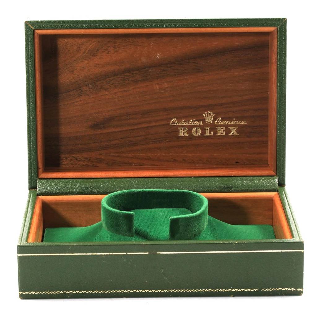 The image shows an open green Rolex Vintage Collection 1680 Men's Stainless Steel Black Dial 1680 Men's Stainless Steel Black Dial watch box, revealing wood and fabric interior.