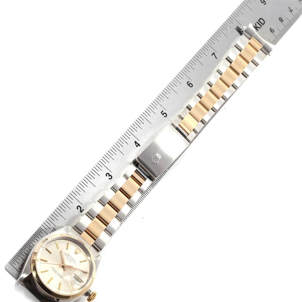 The Rolex Vintage Collection 1500 Men's Steel and Gold (two tone) Silver Dial 1500 Men's Steel and Gold (two tone) Silver Dial watch is shown from above, featuring the face, band, and clasp against a ruler.