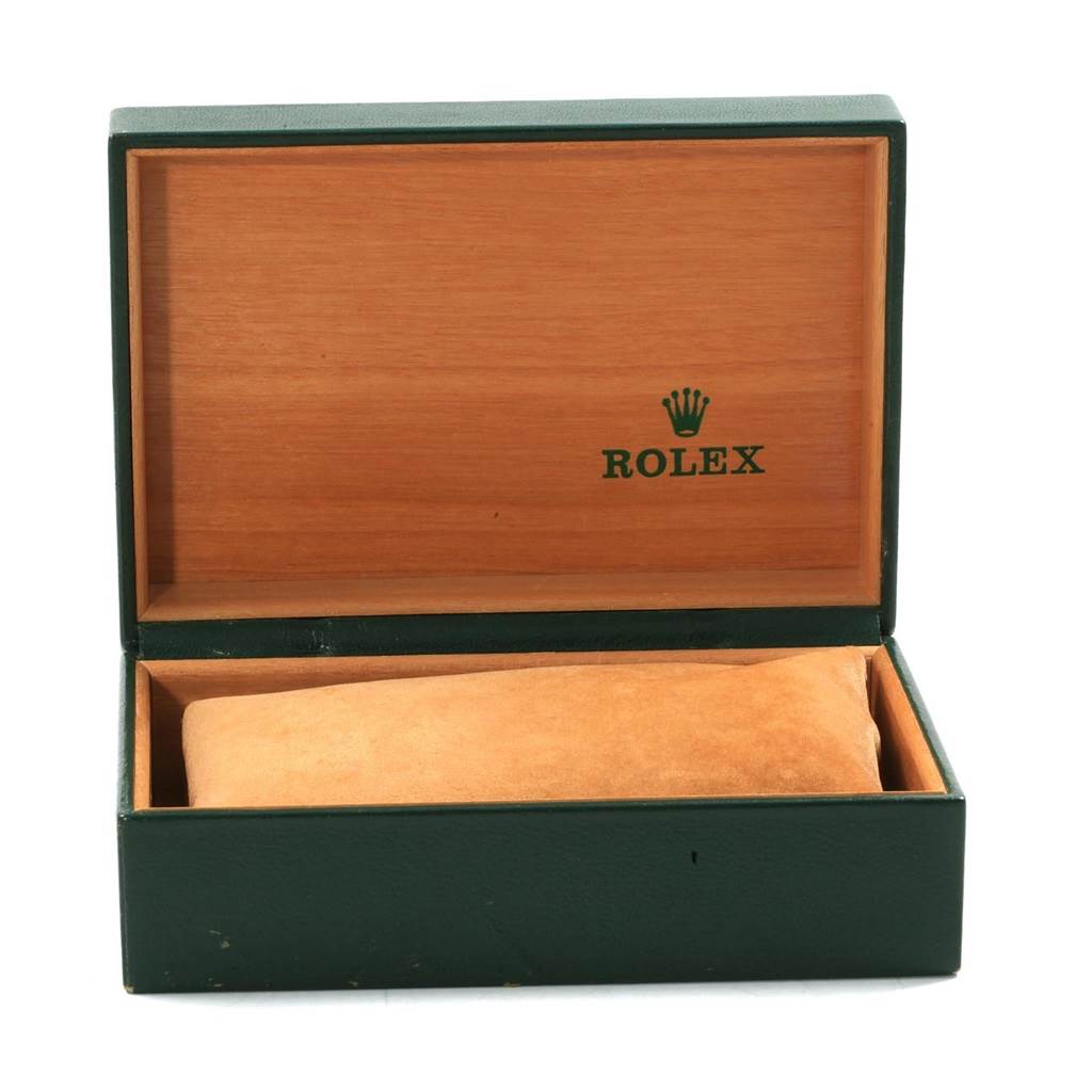 This is an open green and wooden Rolex watch box for the Vintage Collection model.