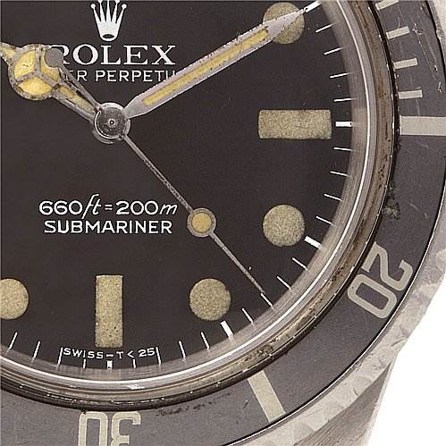 This image shows a close-up of the face and bezel of a Vintage Collection Rolex Submariner watch.