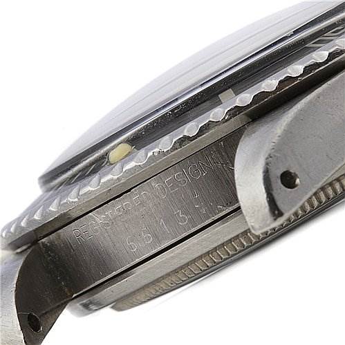 This image shows a close-up side angle of a Rolex Vintage Collection 5513 Men
s Stainless Steel Black Dial 5513 Men
s Stainless Steel Black Dial watch, highlighting the bezel, case, and serial engraving.