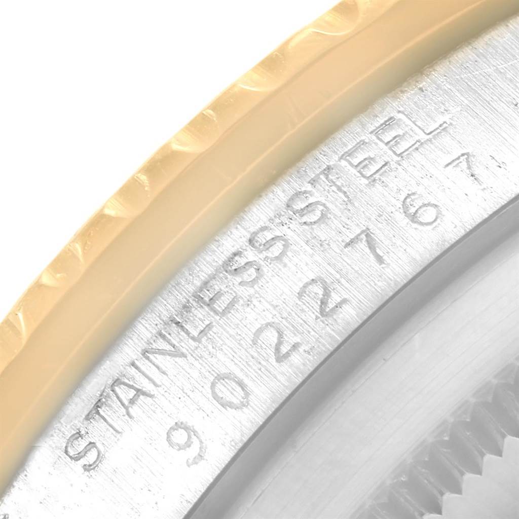 The image shows a close-up of the bezel and part of the case of a Rolex Vintage Collection 16753 Men's Stainless Steel Brown Dial 16753 Men's Stainless Steel Brown Dial watch with stainless steel engraving.