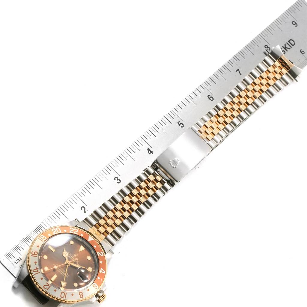 The image shows a Rolex Vintage Collection 16753 Men's Stainless Steel Brown Dial 16753 Men's Stainless Steel Brown Dial watch laid flat with a ruler, displaying the face, bezel, and Jubilee bracelet.