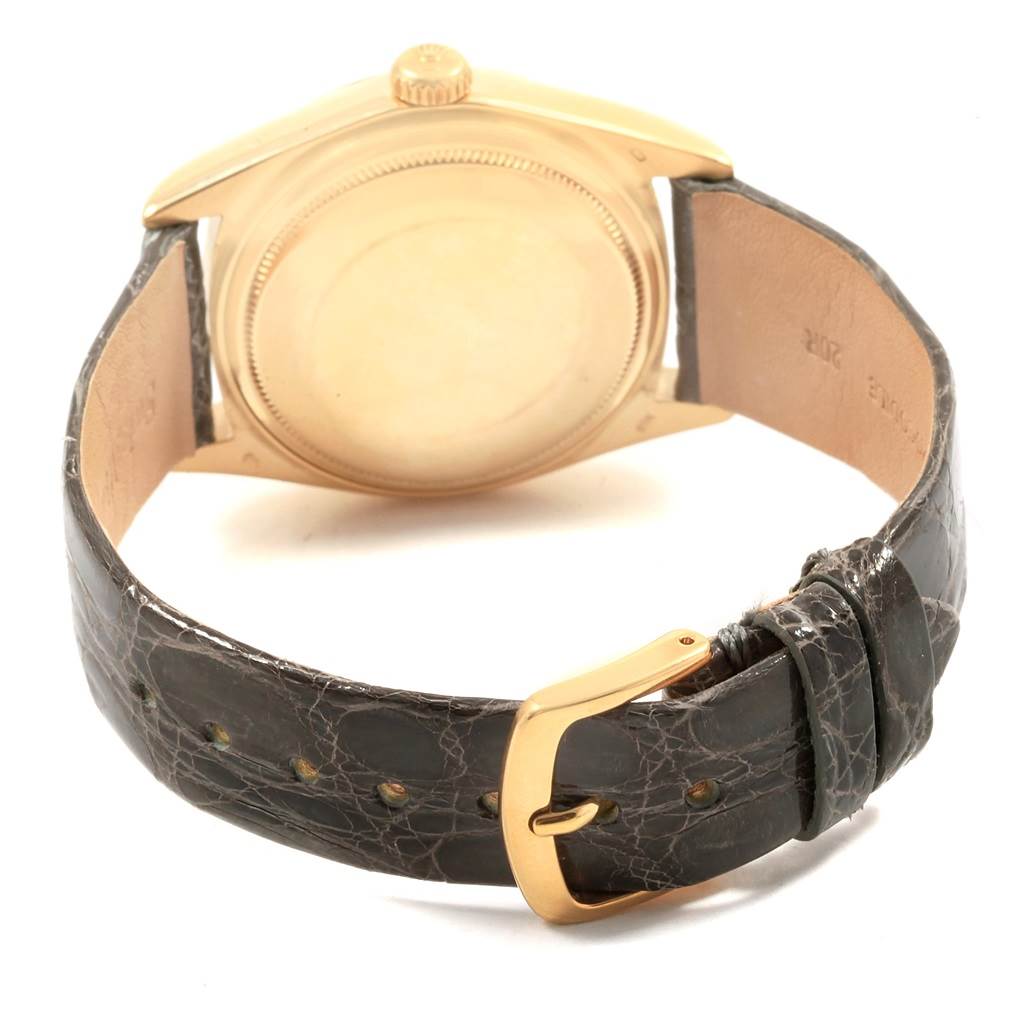 The image shows the back view of a Vintage Collection Rolex watch, focusing on the case back, crown, and black leather strap with a gold tone buckle.