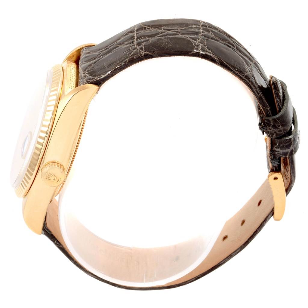 The image shows a side view of the Rolex Vintage Collection 18038 Men's Yellow Gold Silver Dial 18038 Men's Yellow Gold Silver Dial watch, highlighting the crown, case, and leather strap.