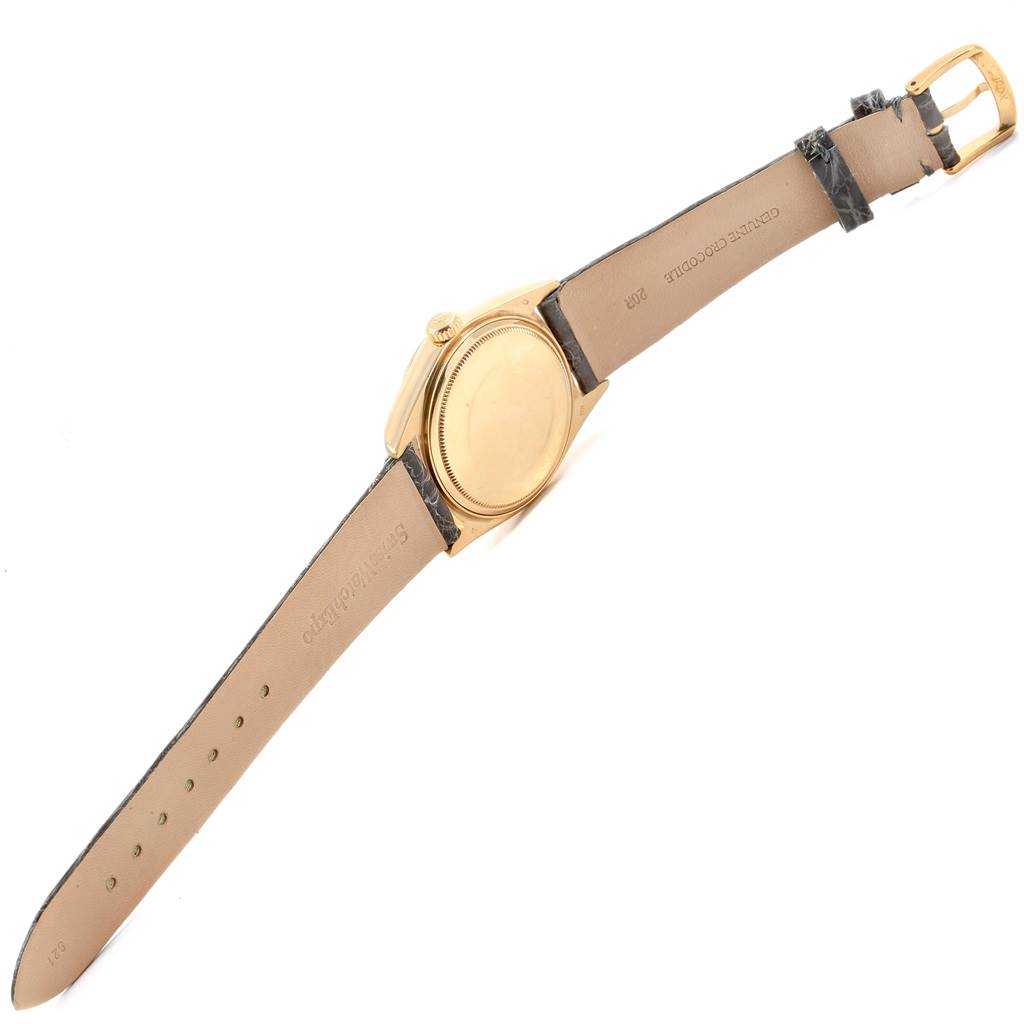 The Rolex Vintage Collection 18038 Men's Yellow Gold Silver Dial 18038 Men's Yellow Gold Silver Dial watch is shown from a rear-side angle, displaying the back of the case and the leather strap.