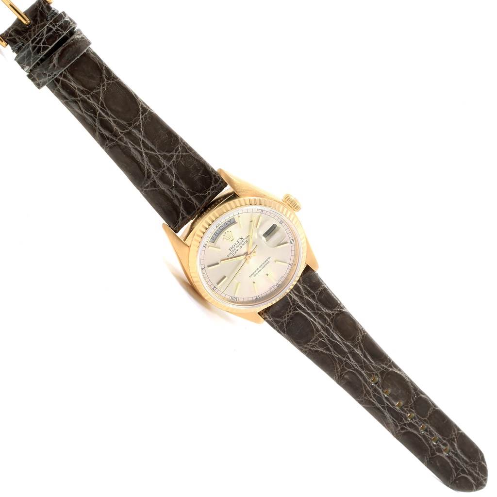 The Rolex Vintage Collection 18038 Men's Yellow Gold Silver Dial 18038 Men's Yellow Gold Silver Dial watch is shown from a top-down angle, highlighting its face, bezel, and leather strap.