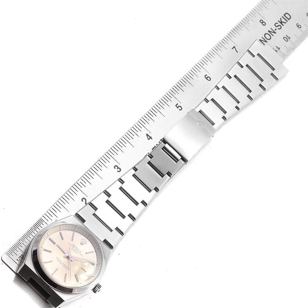 The image shows a Rolex Vintage Collection 1530 Men's Stainless Steel Silver Dial 1530 Men's Stainless Steel Silver Dial watch laid flat, with the watch face and bracelet measured against a ruler.
