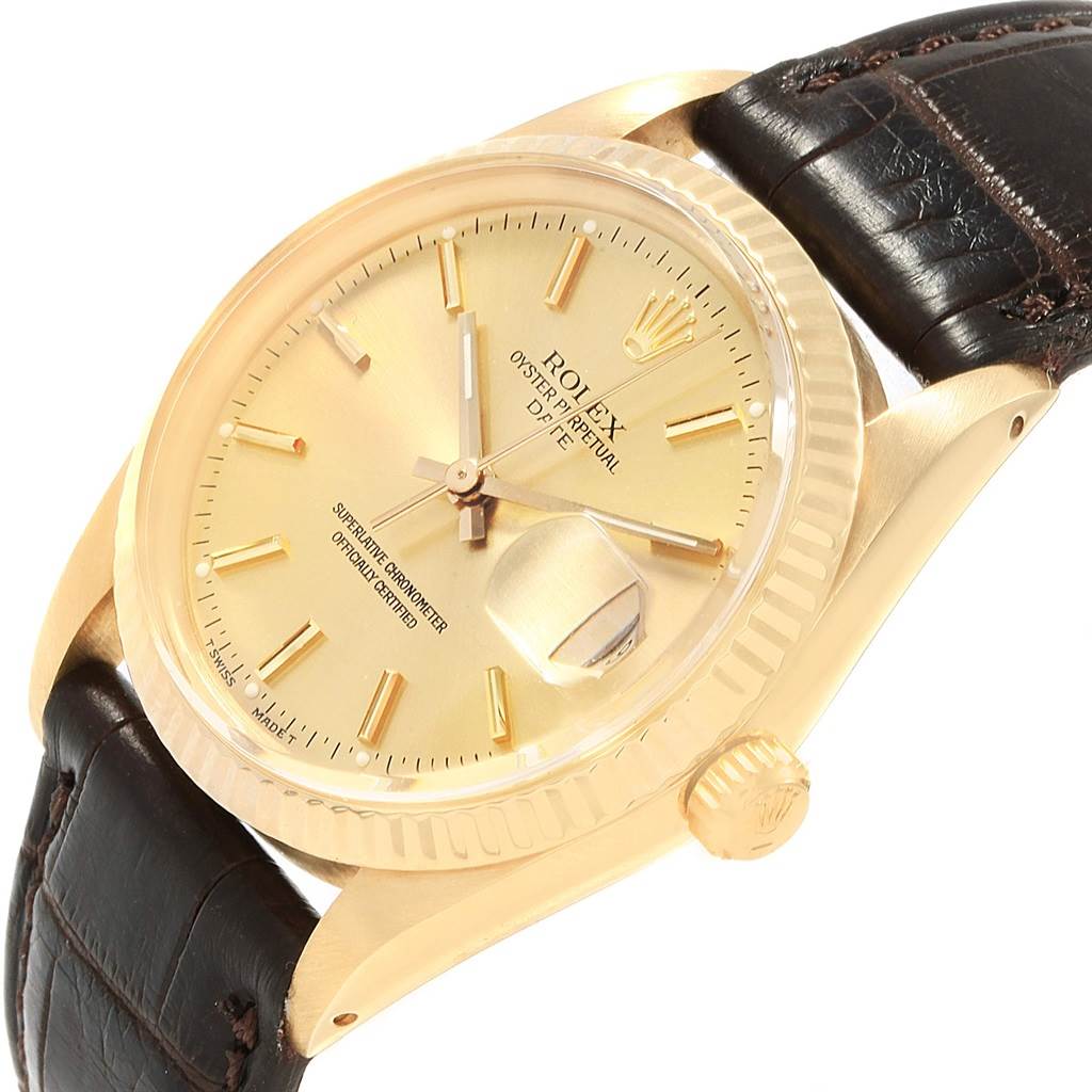 The image shows a close-up of a Rolex Vintage Collection 15037 Men
s Yellow Gold Champagne Dial 15037 Men
s Yellow Gold Champagne Dial watch at an angle, featuring the dial, crown, and part of the leather strap.