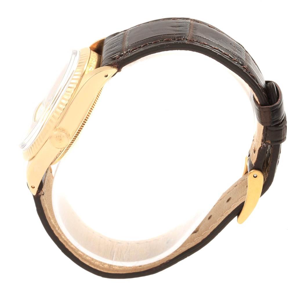 A side view of the Rolex Vintage Collection 15037 Men
s Yellow Gold Champagne Dial 15037 Men
s Yellow Gold Champagne Dial watch, showcasing its gold case and brown leather strap.