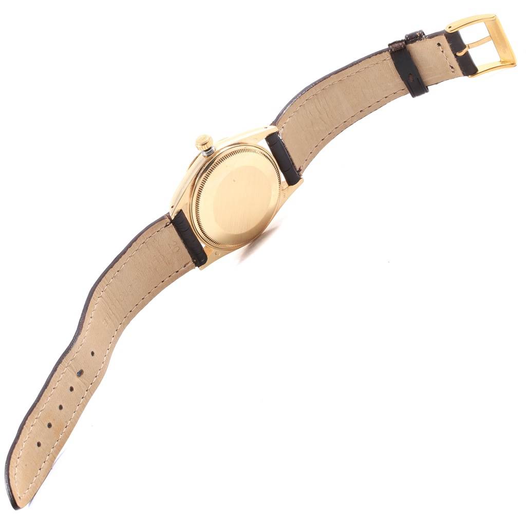 The image shows the back view of the Rolex Vintage Collection 15037 Men
s Yellow Gold Champagne Dial 15037 Men
s Yellow Gold Champagne Dial watch, including the case, crown, and strap.