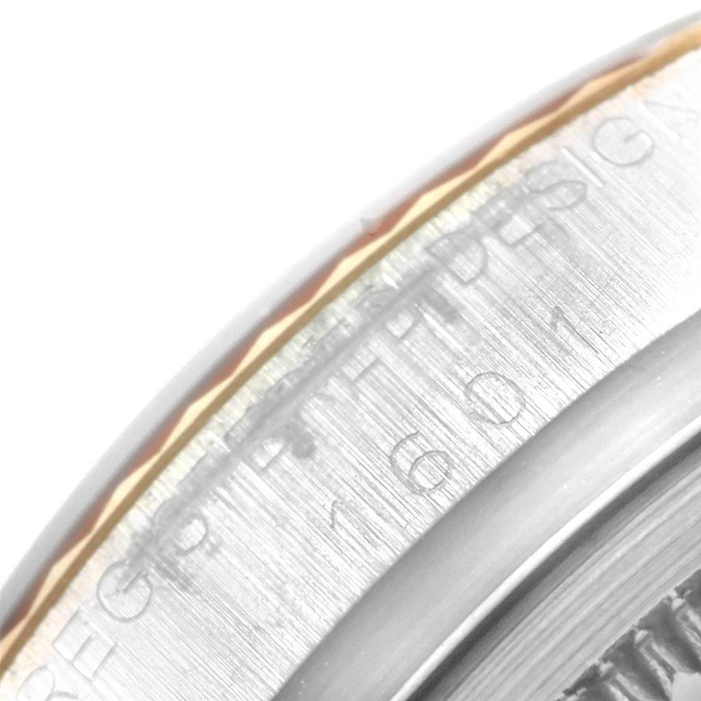This close-up image shows the engraved bezel of the Rolex Vintage Collection 1601 Men's Steel and Gold (two tone) Champagne Dial 1601 Men's Steel and Gold (two tone) Champagne Dial model.
