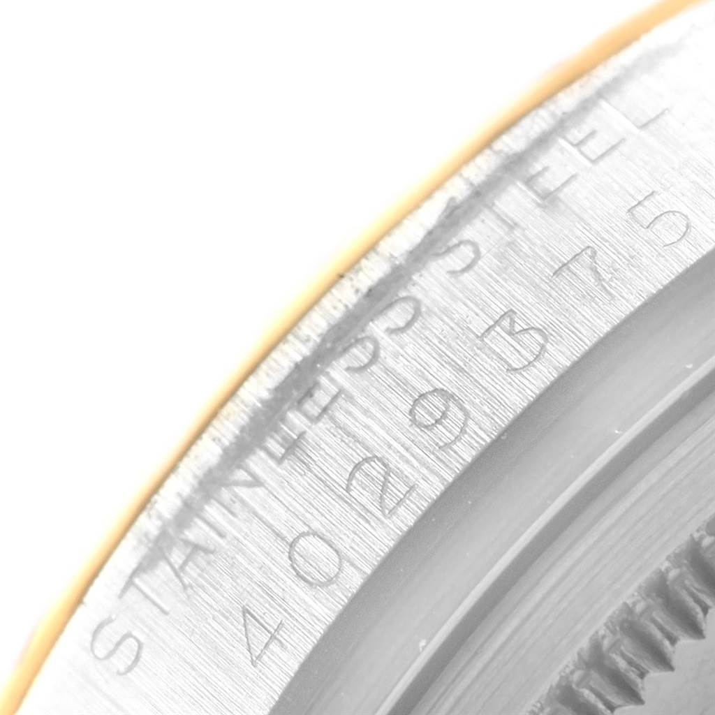 This image shows a close-up of the engraved stainless steel bezel of the Rolex Vintage Collection 1601 Men's Steel and Gold (two tone) Champagne Dial 1601 Men's Steel and Gold (two tone) Champagne Dial watch.