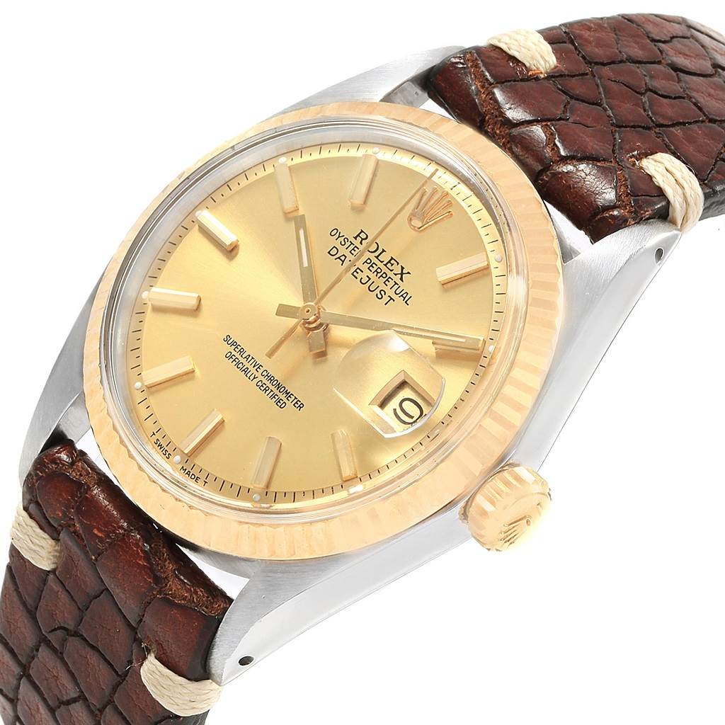 This is an angled view of the Rolex Vintage Collection 1601 Men's Steel and Gold (two tone) Champagne Dial 1601 Men's Steel and Gold (two tone) Champagne Dial watch showcasing its dial, bezel, crown, and part of the leather strap.