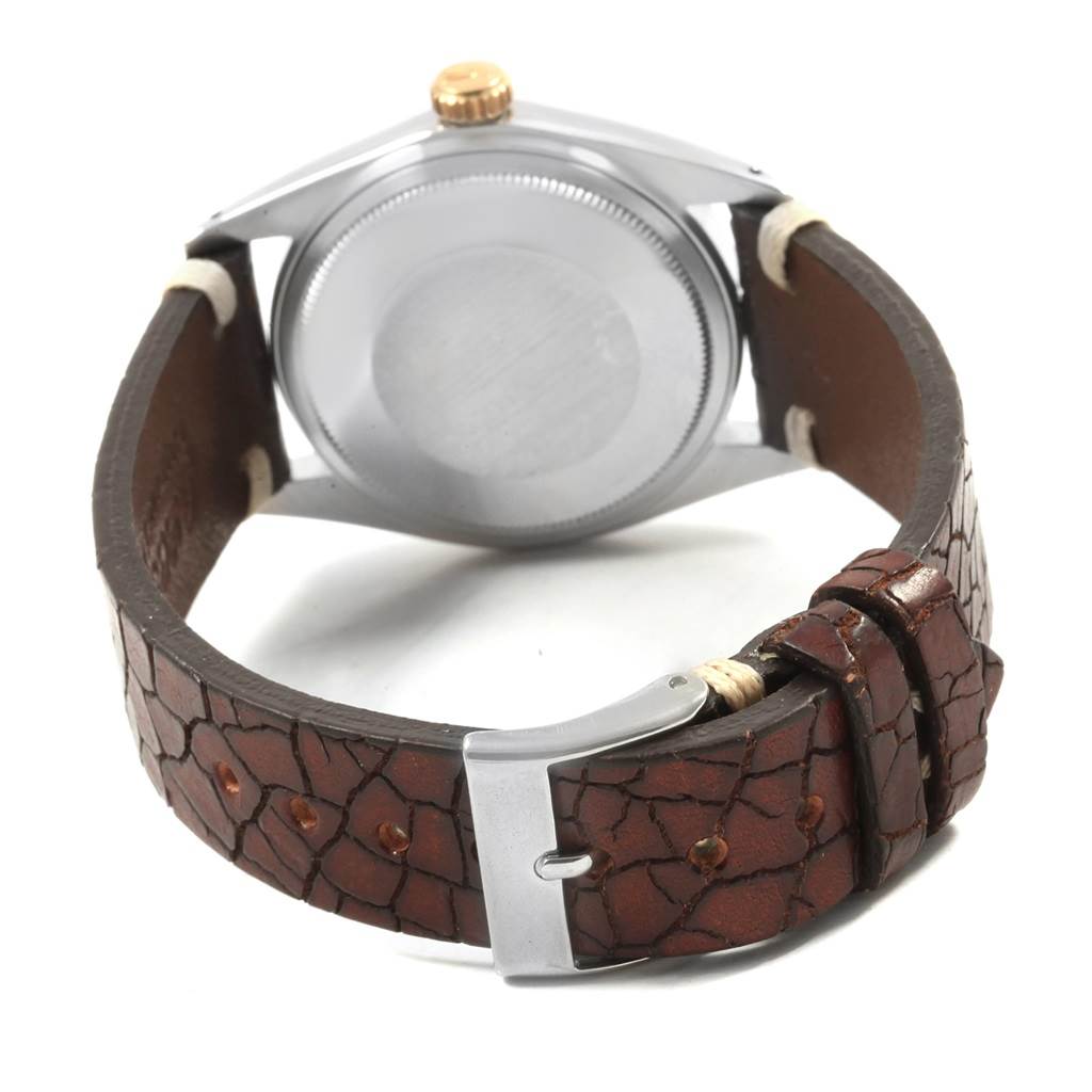 The image shows the back case and strap of the Rolex Vintage Collection 1601 Men's Steel and Gold (two tone) Champagne Dial 1601 Men's Steel and Gold (two tone) Champagne Dial watch, including a close-up of the buckle and strap texture.