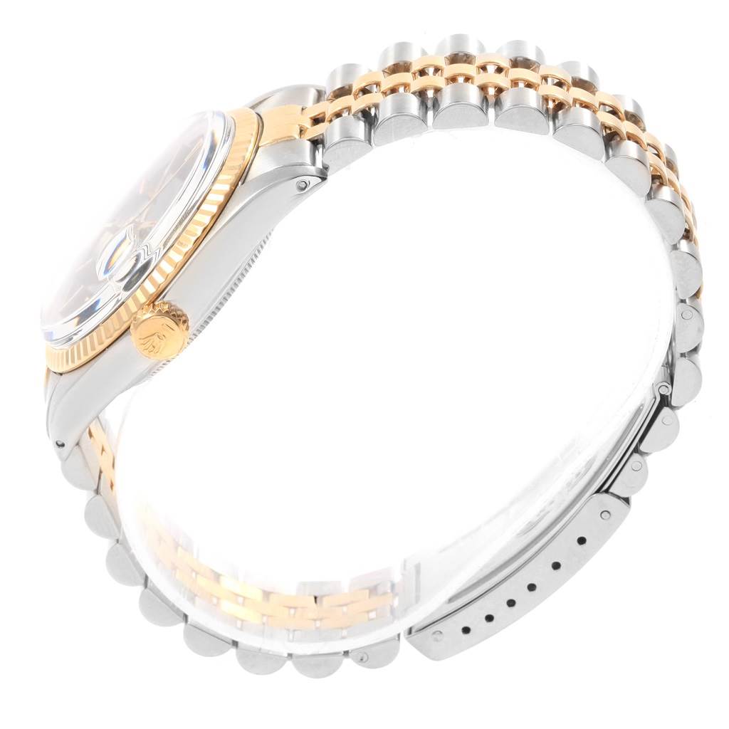 The image shows a side view of the Rolex Vintage Collection 16013 Men's Stainless Steel Black Dial 16013 Men's Stainless Steel Black Dial watch, highlighting its bezel, crown, and two-tone bracelet.