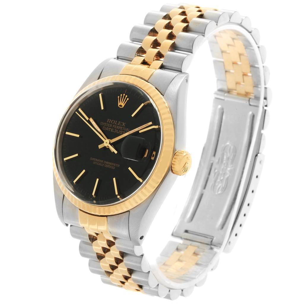 The image shows a Rolex Vintage Collection 16013 Men's Stainless Steel Black Dial 16013 Men's Stainless Steel Black Dial Datejust watch at a three-quarter angle, highlighting its gold and stainless steel bracelet, black dial, and gold bezel.