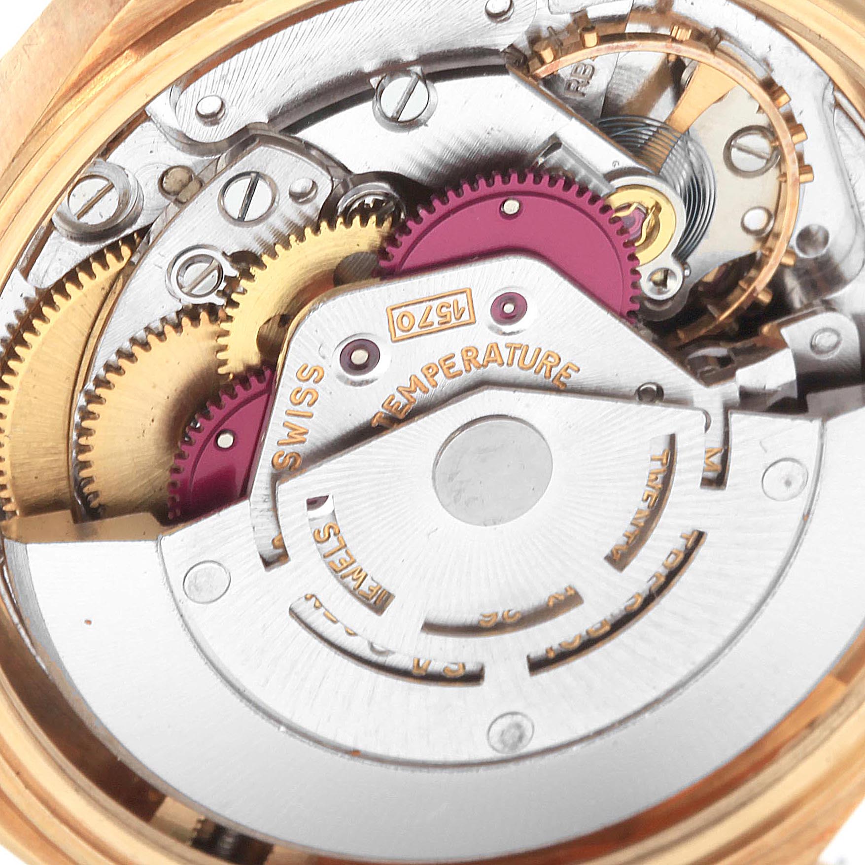 The image shows the internal mechanism of a Vintage Collection Rolex watch, including gears and the balance wheel, viewed from the back.
