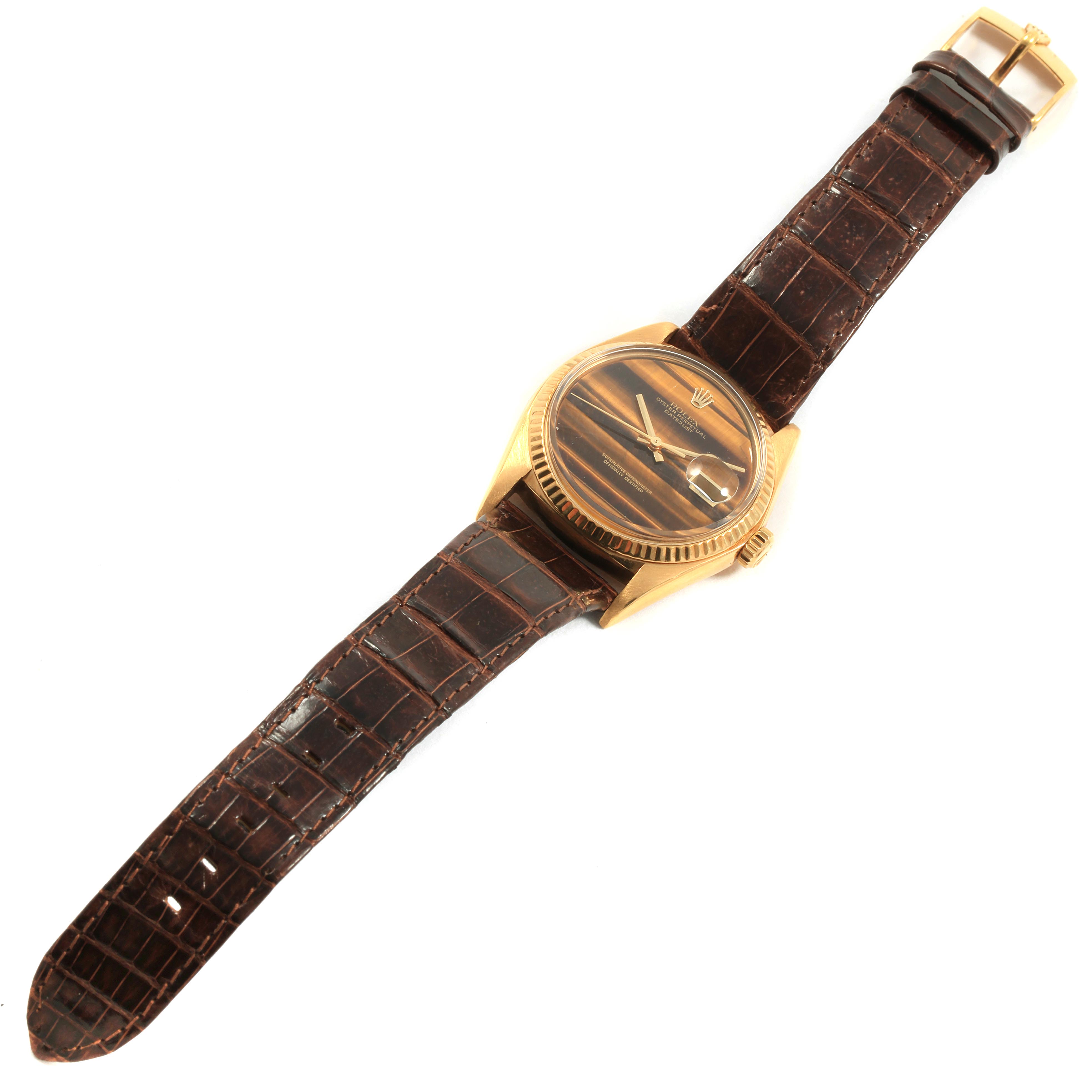 The Rolex Vintage Collection 1601 Men
s Yellow Gold Brown Dial 1601 Men
s Yellow Gold Brown Dial watch is shown from an overhead angle, displaying its dial, bezel, crown, and full leather strap.