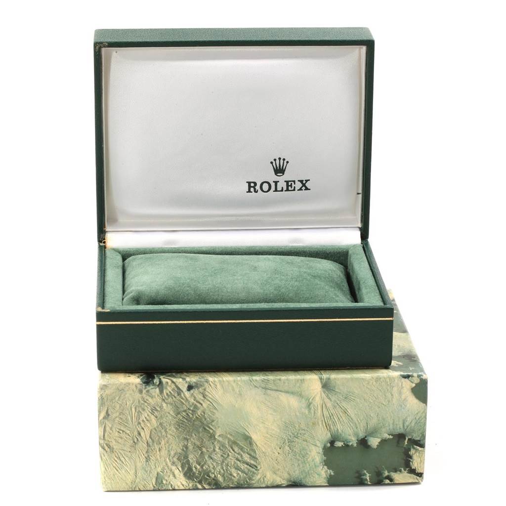 The image shows an open Rolex watch box from the Vintage Collection, with a green cushion and the Rolex logo on the interior lid.