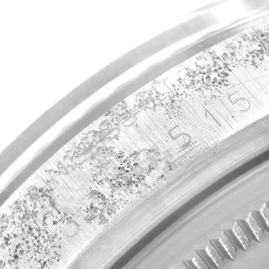This close-up image shows a portion of the case back of a Vintage Collection Rolex watch.