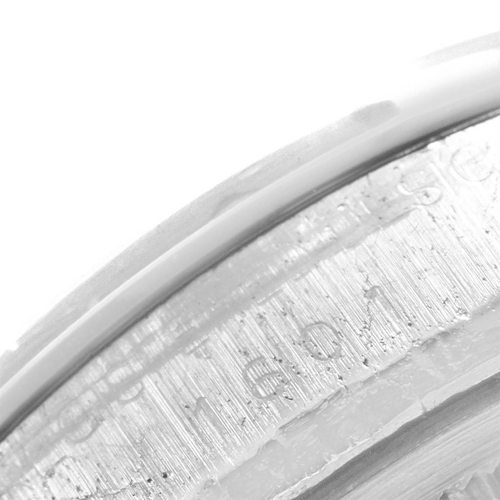The image shows a close-up of the etched serial number on the bezel of the Vintage Collection model by Rolex.