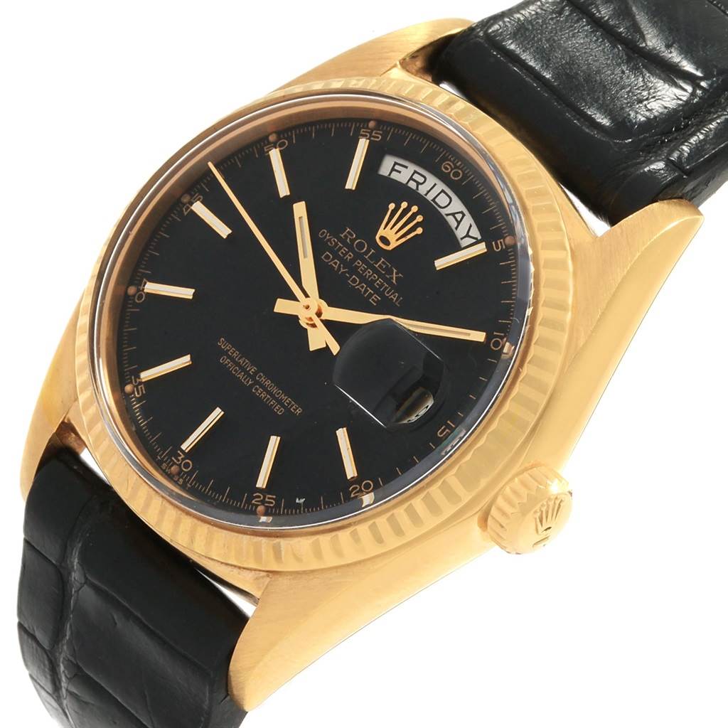 The image shows a Rolex Vintage Collection 1803 Men
s Yellow Gold Black Dial 1803 Men
s Yellow Gold Black Dial watch from a front angle, highlighting its black dial, gold case, day-date feature, and black leather strap.
