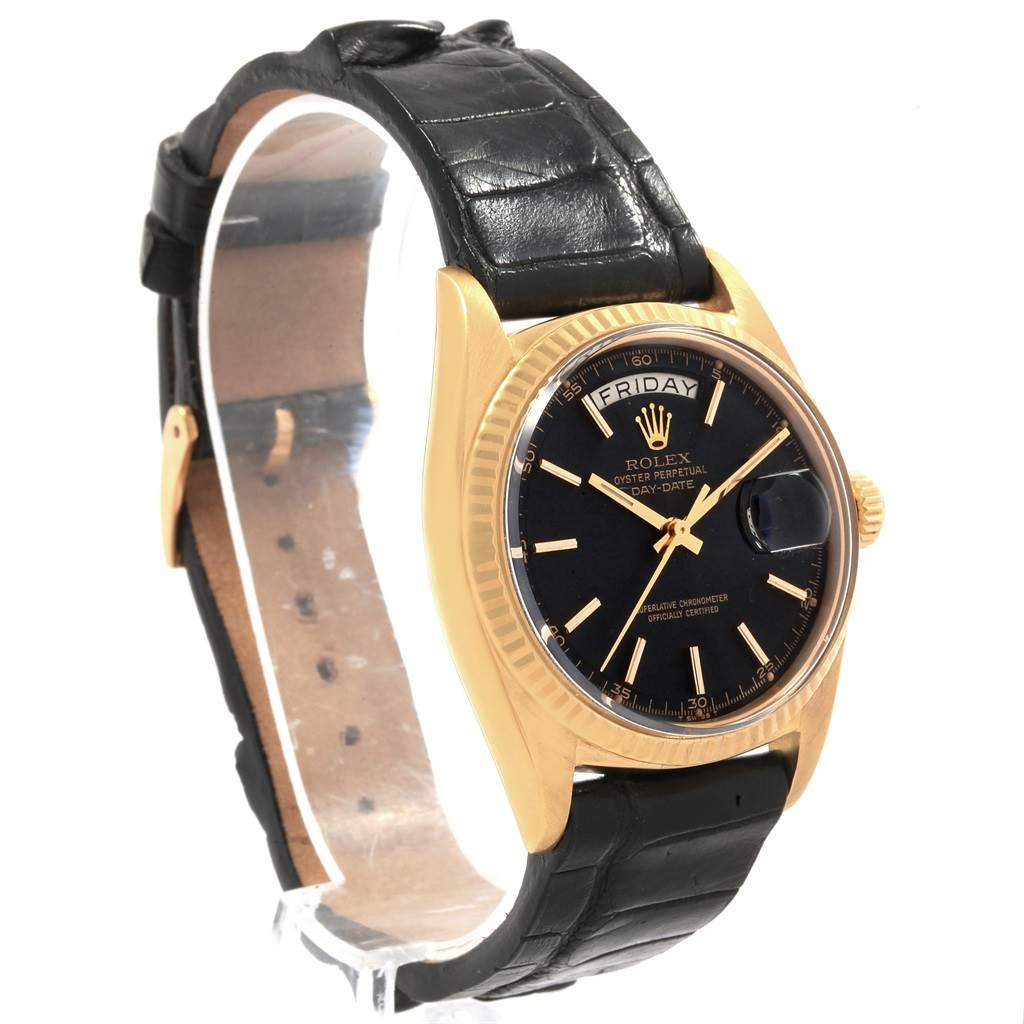 The image shows a Rolex Vintage Collection 1803 Men
s Yellow Gold Black Dial 1803 Men
s Yellow Gold Black Dial watch at an angled side view, highlighting its black dial, leather strap, and gold casing.