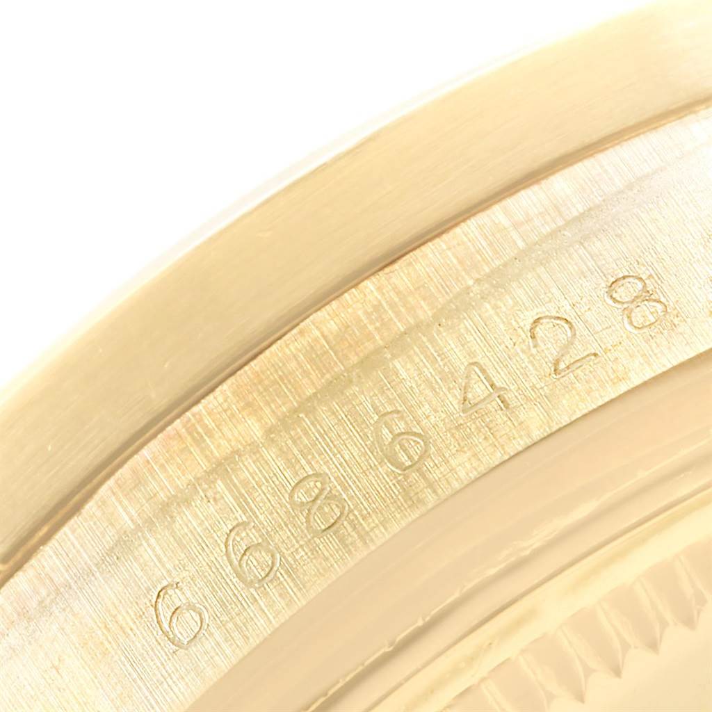 The image shows a close-up of the serial number engraving on a Vintage Collection Rolex watch casing.