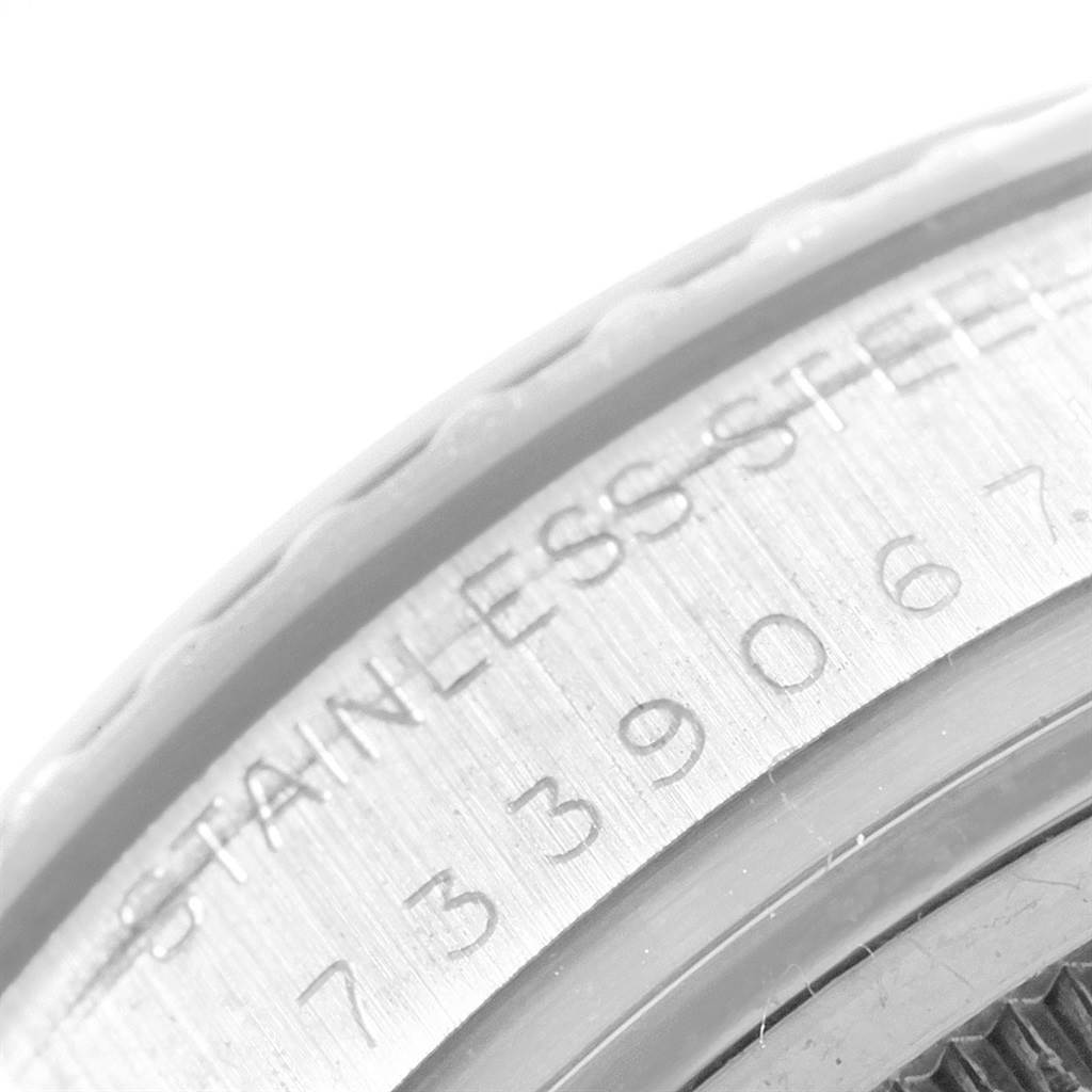 The image shows a close-up of the serial number and "STAINLESS STEEL" engraving on the edge of a Rolex Vintage Collection 16030 Men
s Stainless Steel White Dial 16030 Men
s Stainless Steel White Dial watch.