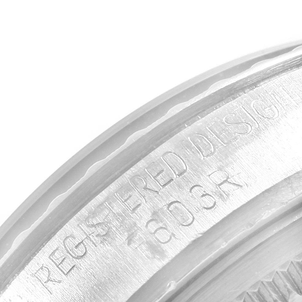 This is a close-up image of the Rolex Vintage Collection 1603 Men
s Stainless Steel Silver Dial 1603 Men
s Stainless Steel Silver Dial watch showing the edge of the case with "REGISTERED DESIGN" engraved.