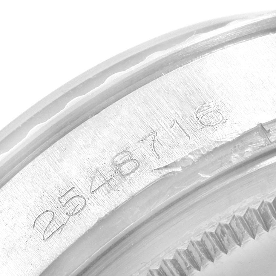 This image shows a close-up of the engraved serial number on the bezel of a Rolex Vintage Collection 1603 Men
s Stainless Steel Silver Dial 1603 Men
s Stainless Steel Silver Dial watch.