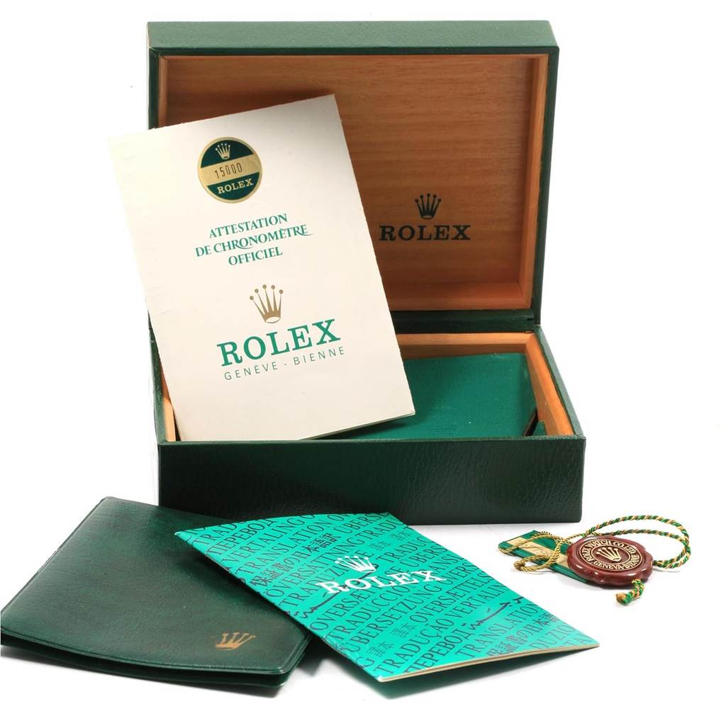 The image shows the open box and paperwork for a Vintage Collection Rolex watch, including manuals and a certification booklet.