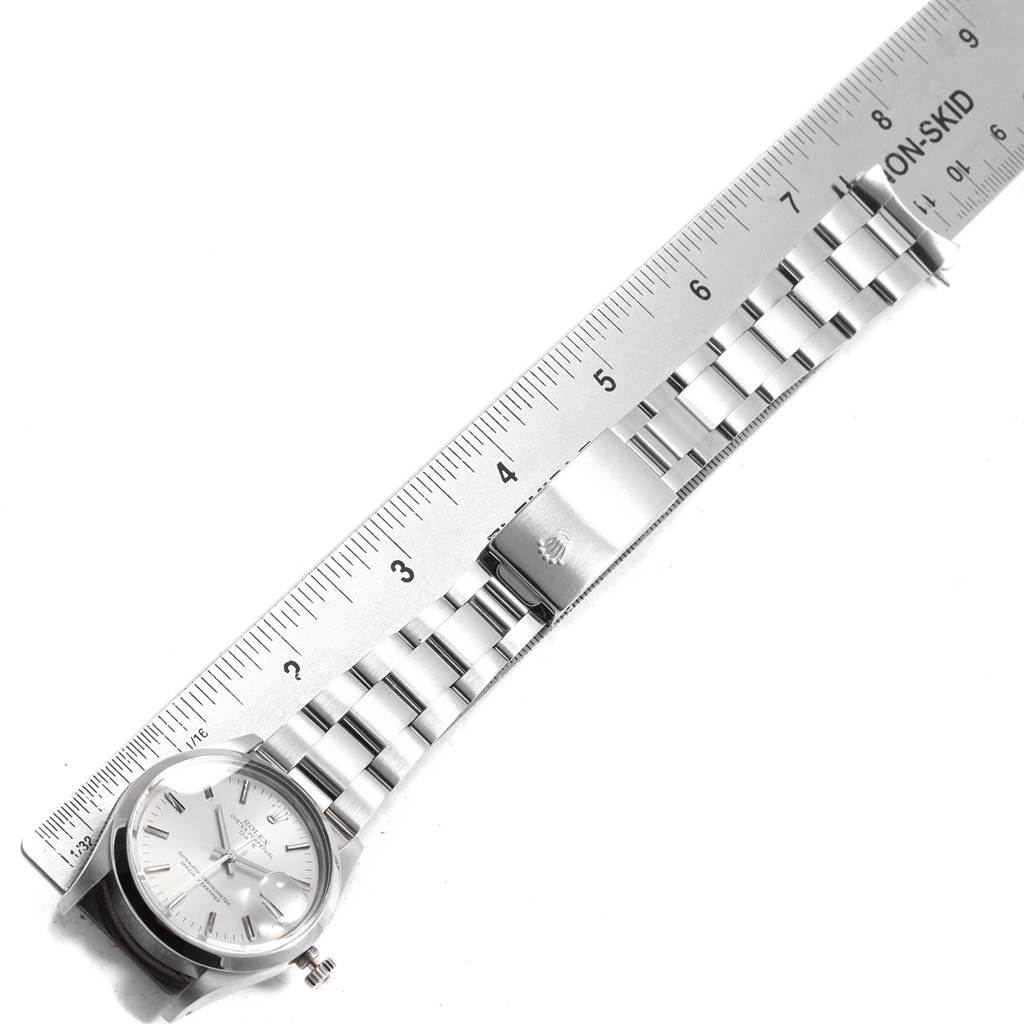 The image shows the face and bracelet of the Rolex Vintage Collection 15000 Men's Stainless Steel Silver Dial 15000 Men's Stainless Steel Silver Dial model watch, laid next to a ruler for measurement.